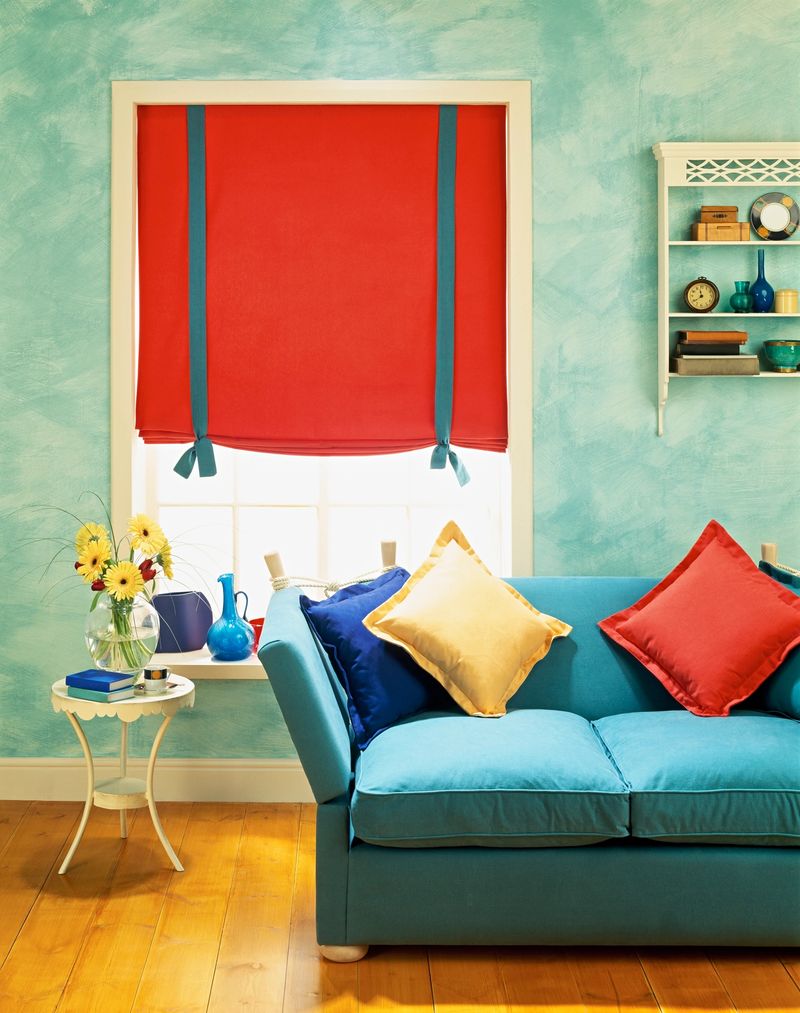 View of colorful living room interior with couch and side table