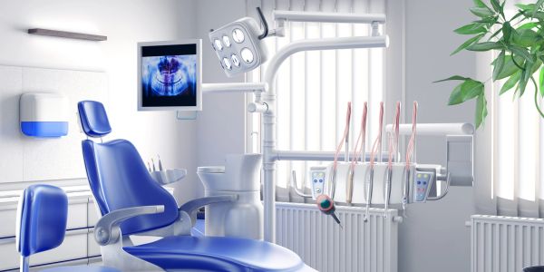 Modern dental clinic with blue chairs and dental equipment.