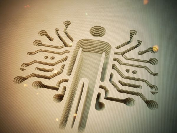 Cutout human figure with circuit-like patterns extending outward, symbolizing technology integration.