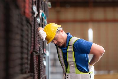 alt="labor worker in pain"