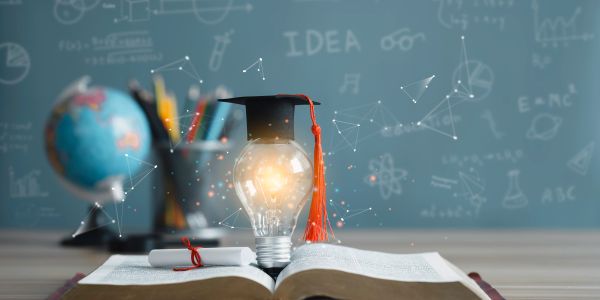Graduation cap on lightbulb symbolizing ideas and learning.