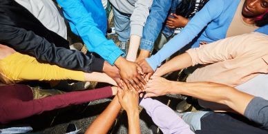 Group of hands joined together in unity.
