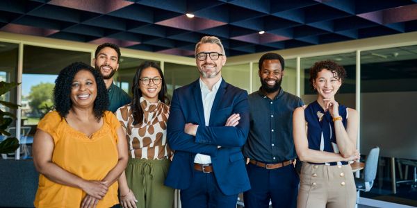 Diverse group of professionals posing in an office.