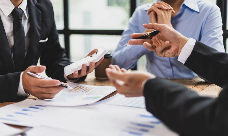 Business meeting, Business partners and colleagues in office discussing strategic analysis and planning business investment projects together.