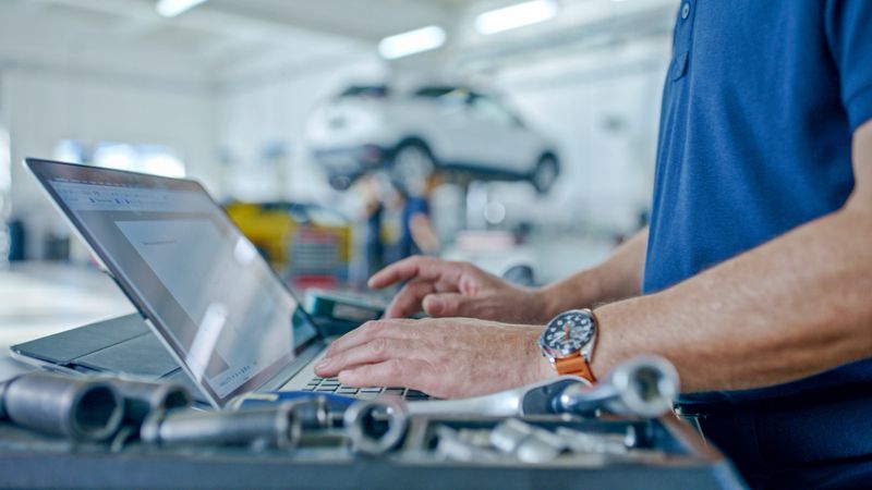 Hands Of Manager At The Auto Repair Shop Planning Operations Using Laptop