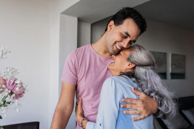 Adult child and older parent together, representing adding an adult child to property title in Ontar