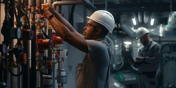 Gas Safe engineer from Phoenix Gas and Heating standing beside branded van after completing a boiler