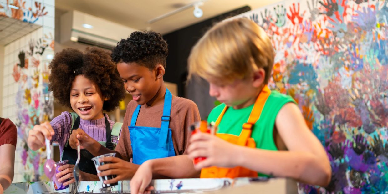 Children happily painting together at an art class.