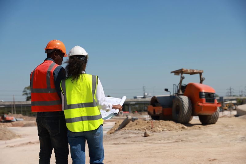 Coworkers doing a meeting in a construction site
