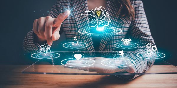 Businesswoman interacts with futuristic digital interface showing innovation and collaboration icons.