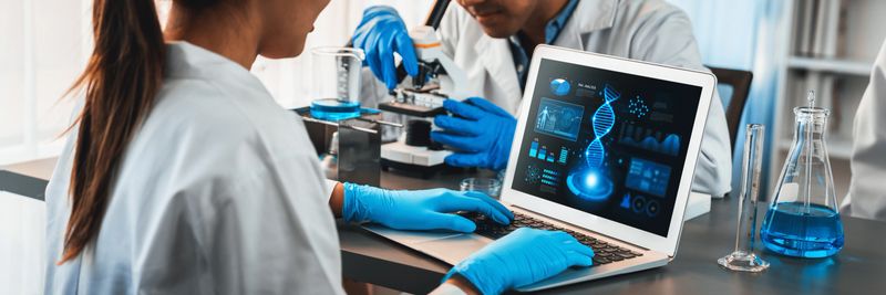 Dedicated scientist group working on advance biotechnology computer software to study or analyze DNA data after making scientific breakthrough from chemical experiment on medical laboratory. Neoteric