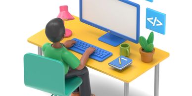 Person coding at a desk with a computer and accessories.