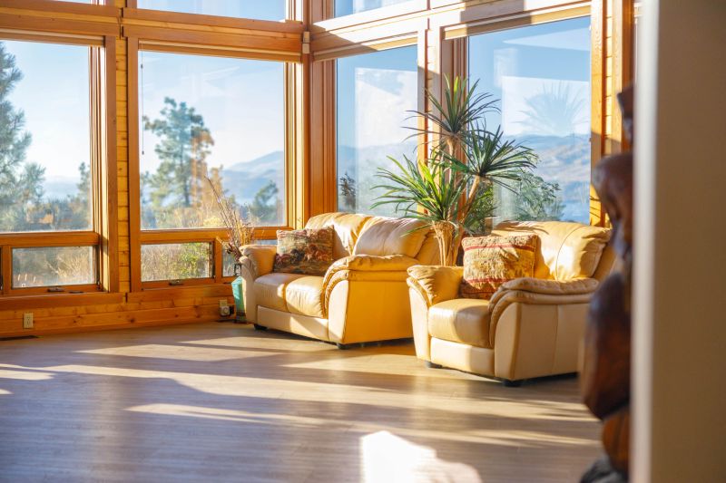 This brightly lit living room features abundant natural light from the large windowsv