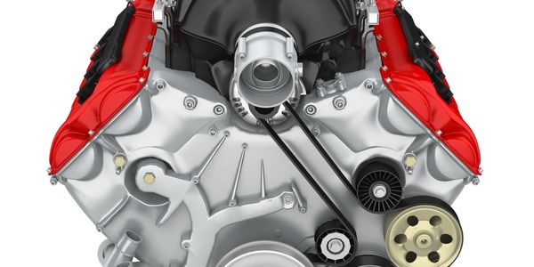 Front view of a V8 car engine with red valve covers and black intake manifold.