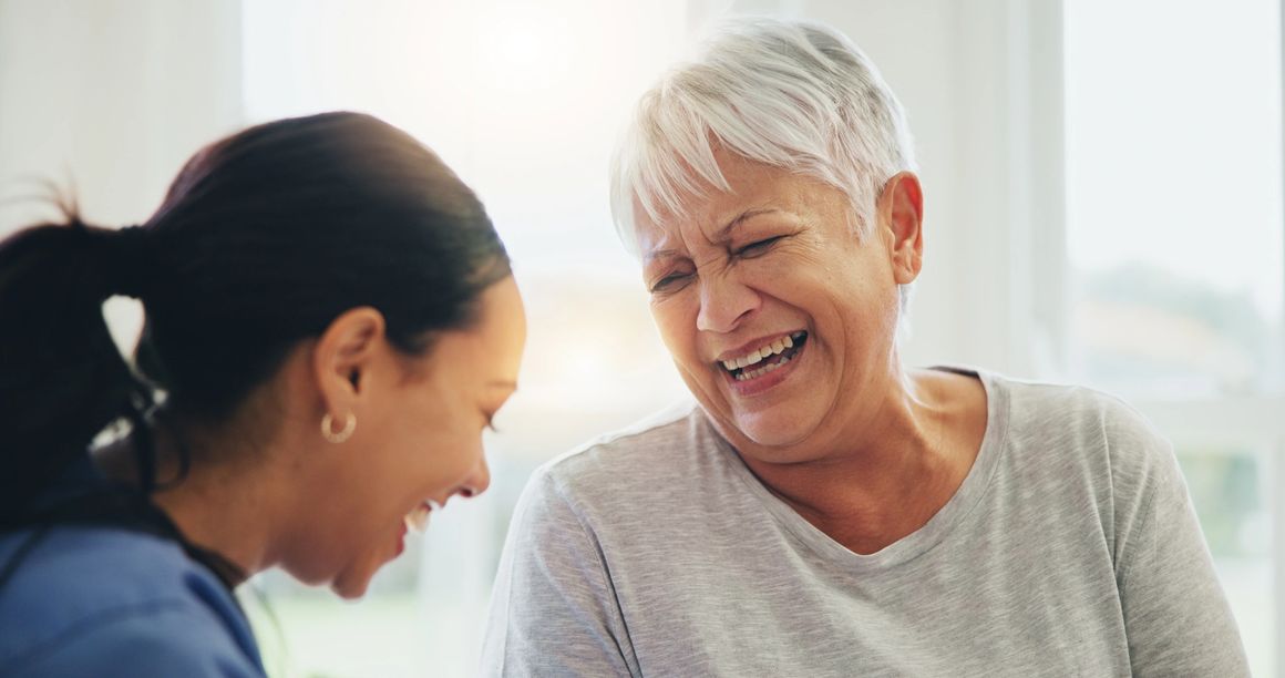 Two women laughing and enjoying a moment together.
