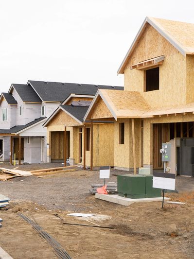 New houses under construction in a developing neighborhood.
