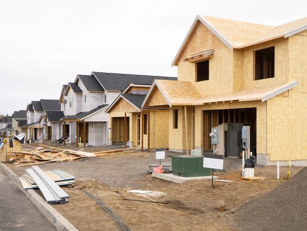 Row of newly constructed houses in a developing neighborhood.
