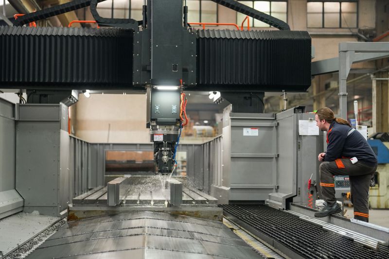 Technician man checking the operation of cnc machine in industry
