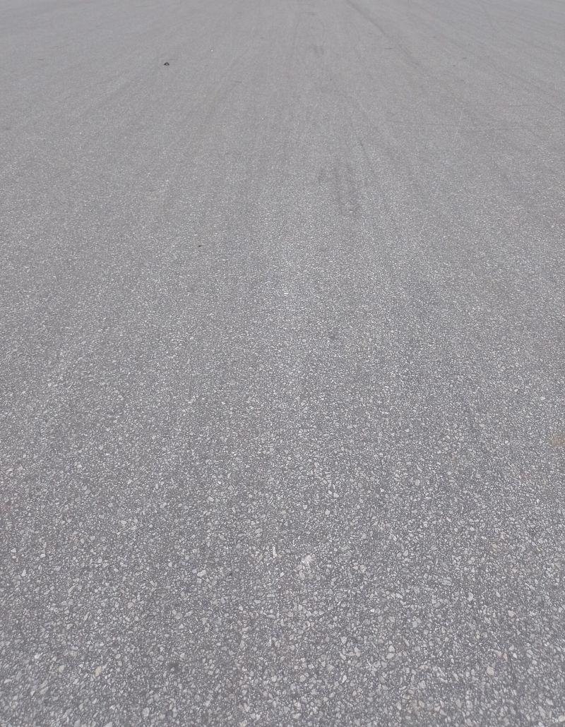 Gray asphalt, small stone texture like gravel and granite