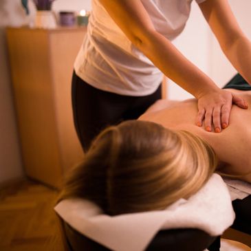 Person receiving a relaxing back massage in a cozy room.