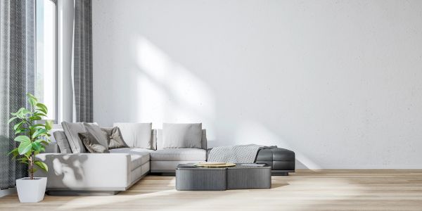 Modern living room with a white sectional sofa and large window.