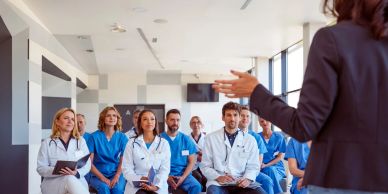 Medical team attentively listening to a presenter.