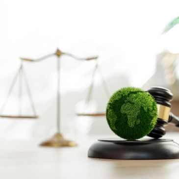 Gavel with green Earth globe and scales of justice.