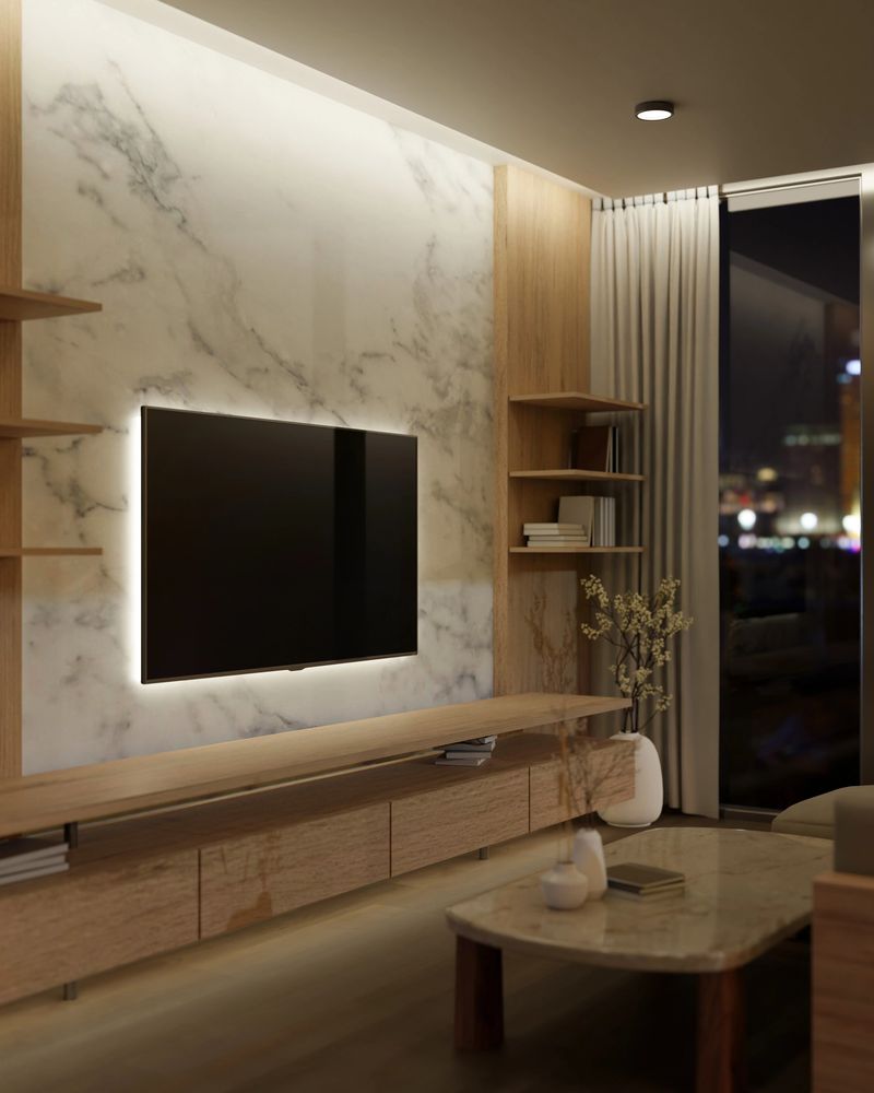 Interior design of a modern luxury living room at night with a TV attached on a marble wall, a modern wooden built-in cabinet, a coffee table, and a large glass window. 3d render, 3d illustration