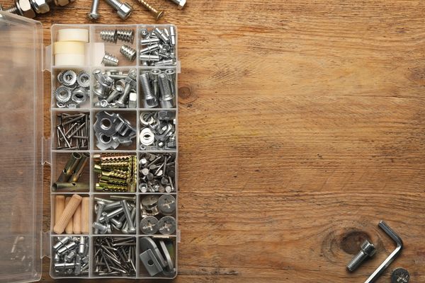 Organized screws and hardware in a plastic divider box.