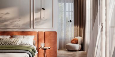 Sunlit modern bedroom with terracotta bed and cozy reading nook.