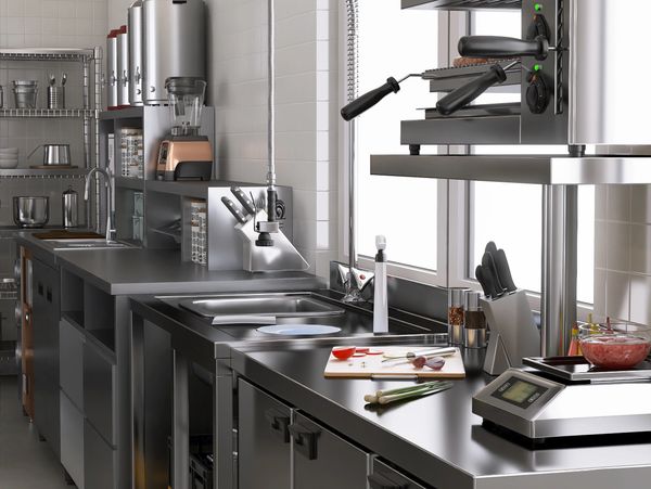 Modern stainless steel kitchen with appliances and utensils.