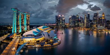 Singapore city skyline at night looking across the water and the city is lit up