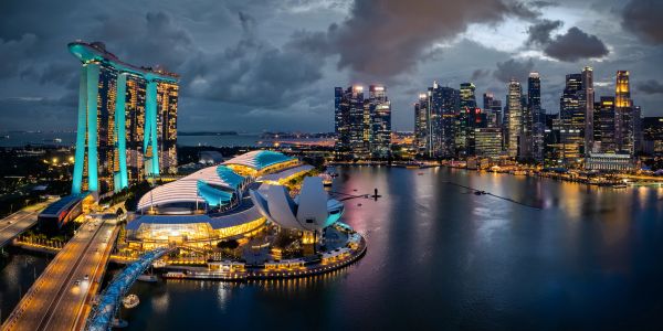 Night view of Singapore skyline with Marina Bay Sands illuminated.