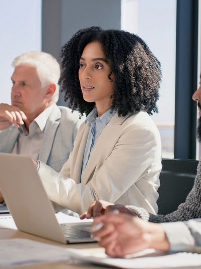 Businesswoman attentively listening in a meeting.