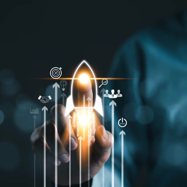 Hand touching a glowing rocket icon symbolizing startup growth and success.