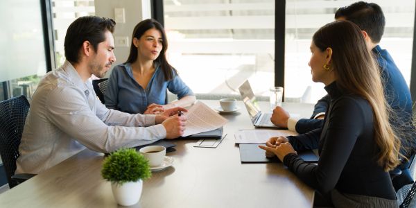 Four people having a business meeting.