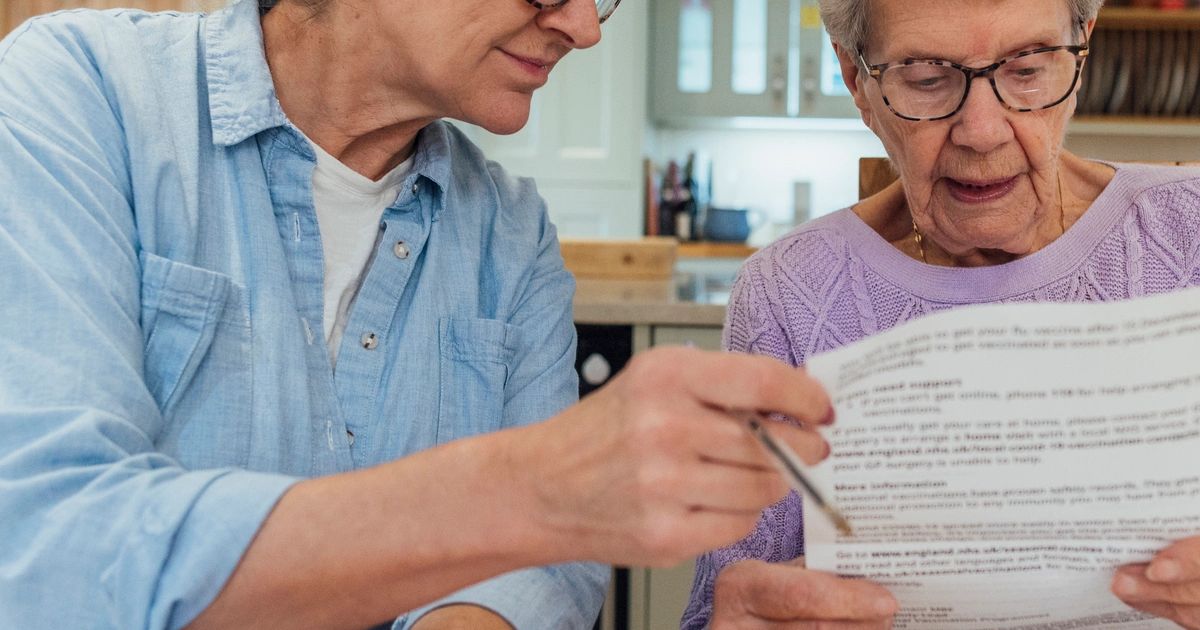 Adult child reviewing inherited home estate documents and paperwork
