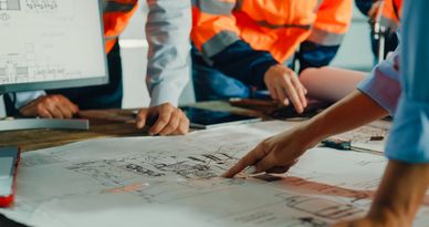 Team reviewing architectural blueprints.