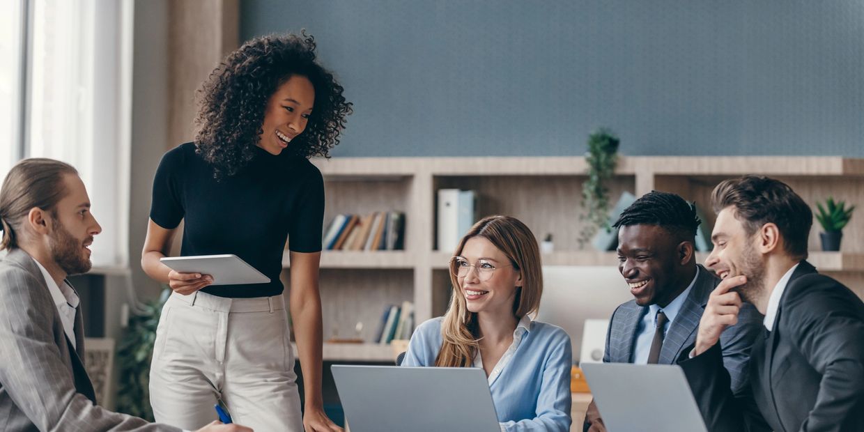 2 women and 3 men in a conference room