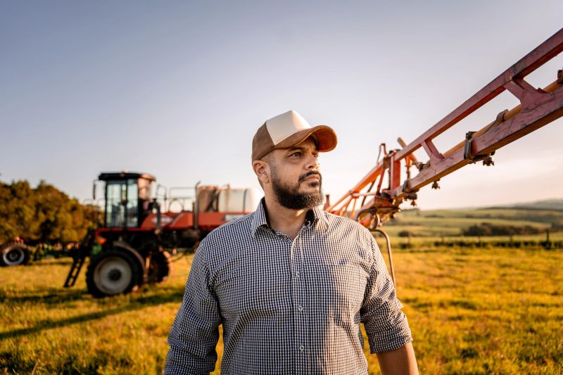 Portrait of a farmer in front of his agricultural machine