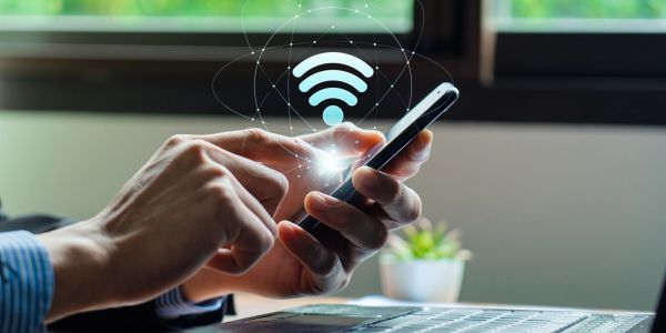 Person accessing Wi-Fi on smartphone indoors.