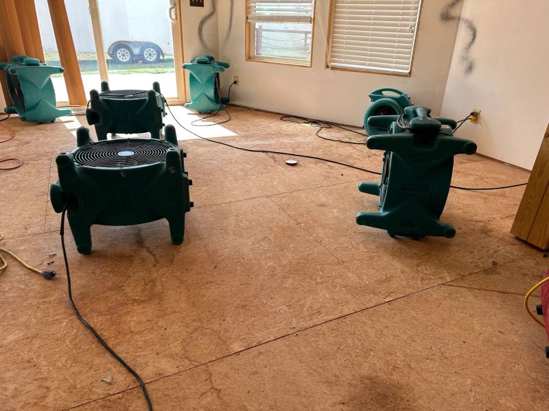 A group of air movers drying out a home after a water loss