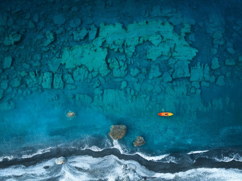 Aerial drone view of a kayak in Agios Pavlos beach (Crete).