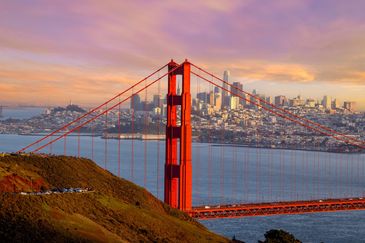 Golden Gate Bridge with San Francisco skyline at sunset.