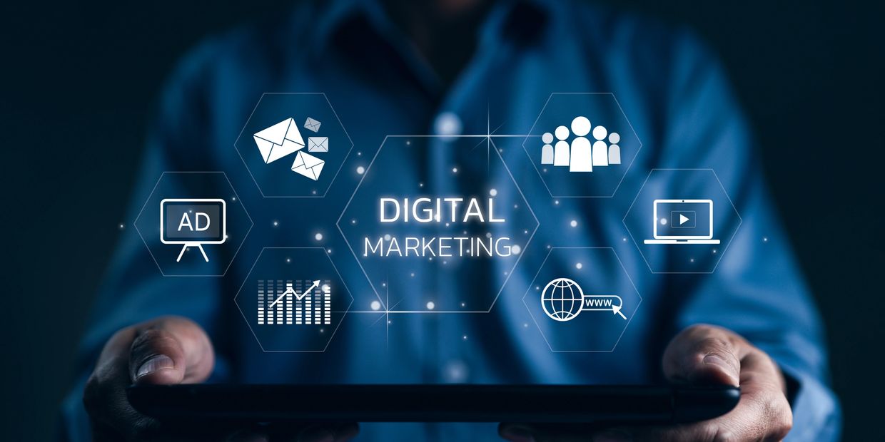 Man in blue shirt holding a tray with text that reads "digital marketing"