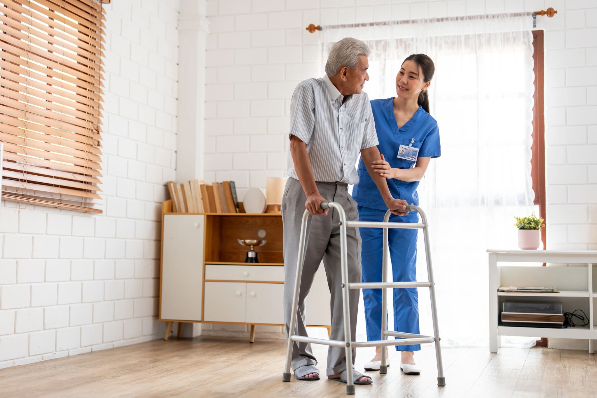 Caregiver supporting a senior in a bright residential environment