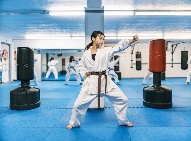 Young Karate fighters, school age children practising karate. They are all dressed in karategi-karate uniform. Interior of karate school in Mississauga, Ontario in Canada.