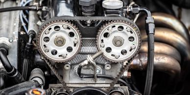Close-up of a car engine's timing belt and gears.