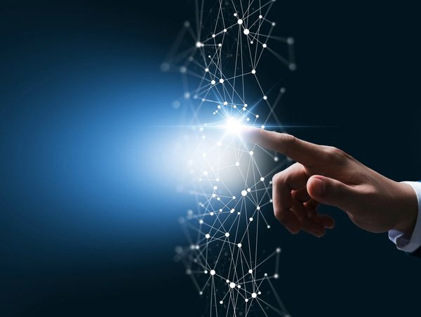 A hand touching a glowing network of connected dots and lines.