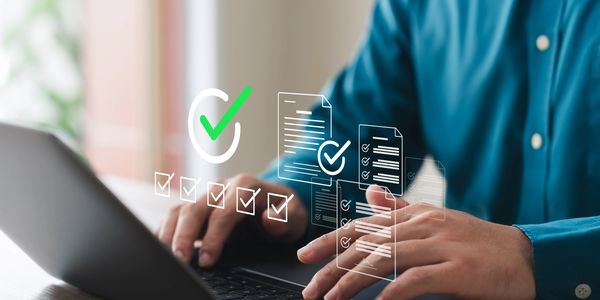 Person typing on laptop with digital checklists and documents floating above keyboard.
